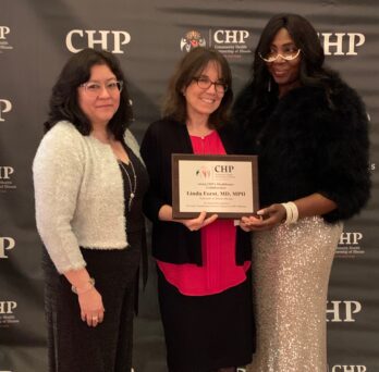 Director of the Great Lakes Center for Farmworker Health and Wellbeing receives an award from the Executive Director of Community Health Partnerships of Illinois for her longstanding work with farmworkers. 